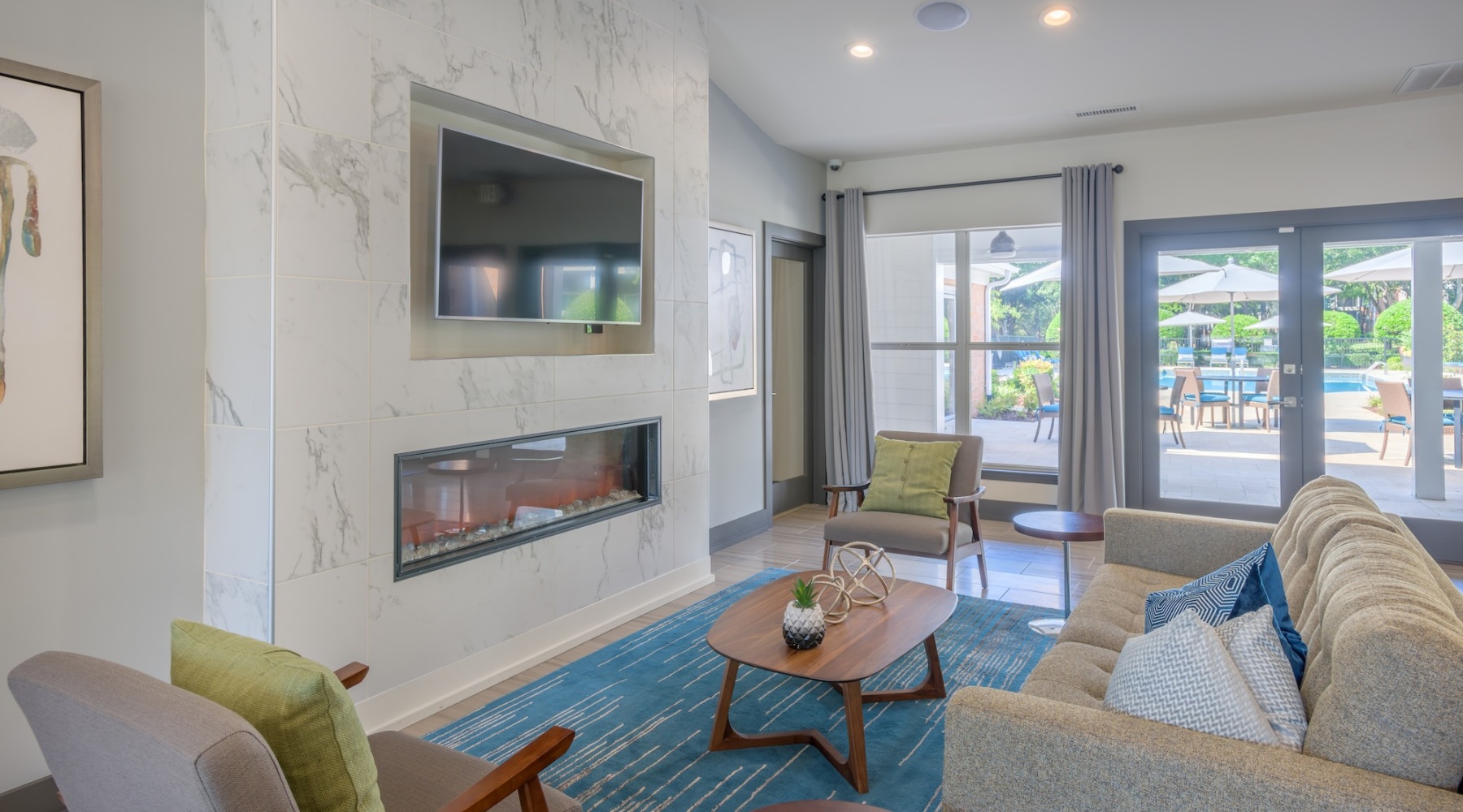 Clubhouse at Presley Oaks with a fireplace and seating around the coffee table at our apartments in Charlotte, North Carolina.